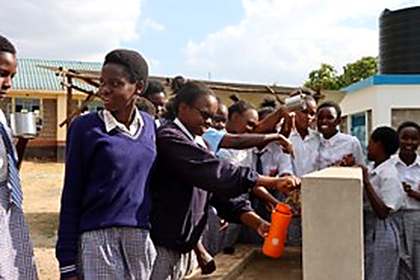 Students filling their bottles at the school tap